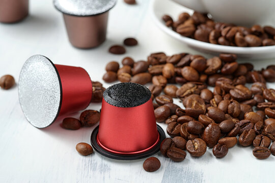 Closeup of roasted coffee beans and coffee capsules