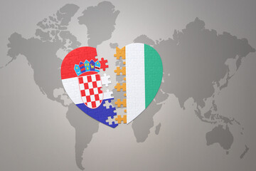 puzzle heart with the national flag of croatia and cote divoire on a world map background.Concept.