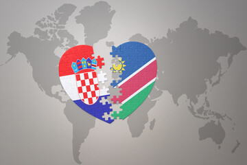 puzzle heart with the national flag of croatia and namibia on a world map background.Concept.