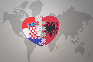 puzzle heart with the national flag of croatia and albania on a world map background.Concept.