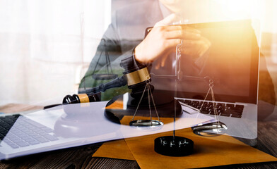 Business and lawyers discussing contract papers with brass scale on desk in office. Law, legal services, advice, justice and law concept picture with film grain effect