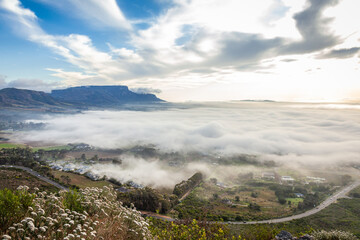 Fototapeta na wymiar The southern suburbs of Cape Town from silvermine, covered in fog down below.