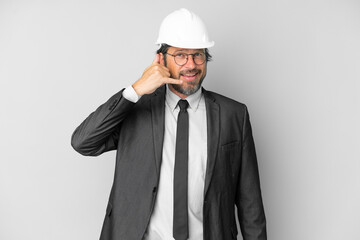 Young architect man with helmet over isolated background making phone gesture. Call me back sign