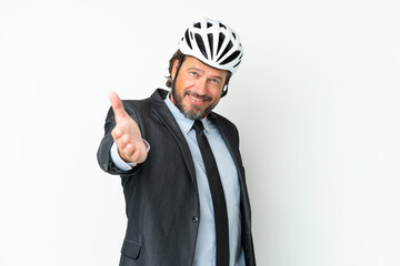 Business senior man with a bike helmet isolated on white background shaking hands for closing a good deal