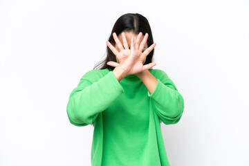 Young Colombian woman isolated on white background nervous stretching hands to the front