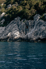 view of the rocky coastline from a boat on the sea