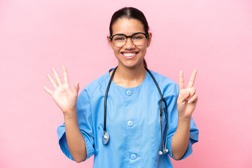 Young nurse Colombian woman isolated on pink background counting seven with fingers