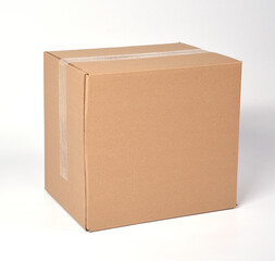 brown cardboard box sealed with adhesive tape on a white background