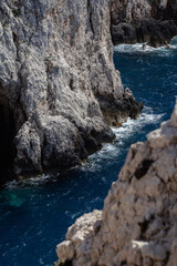 waves crashing on beautiful rocks in the sea during sunny day