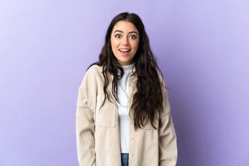 Young caucasian woman isolated on purple background with surprise facial expression