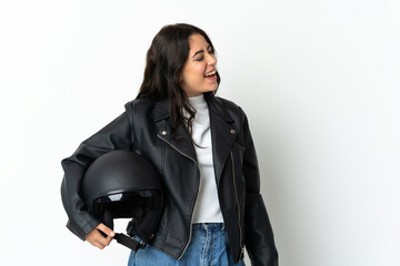 Woman holding a motorcycle helmet isolated on white background laughing in lateral position