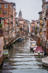Fototapeta na wymiar View of a Canal in Venice with a Pedestrian Bridge, Veneto, Italy, Europe, World Heritage Site