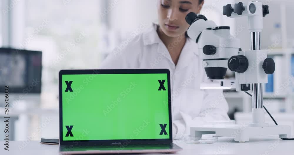 Poster Female scientist analyzing organisms under a microscope and a laptop with a green screen. Female technician working on research in a lab with modern technology. Biologist looking at a lab sample