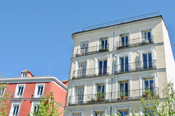 Fototapeta na wymiar Classical residential houses with retro windows and shutters downtown district of Madrid, Spain