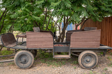 Wooden wagon vintage for a trip and travel in the summer. Outdoors.