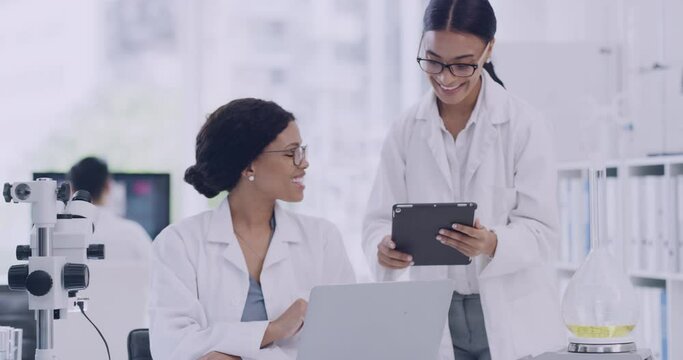 Team of laboratory scientists using digital tablet and celebrating with high five gesture after genetic breakthrough in monkeypox cure. Two pathologists coworkers, biochemical engineers using laptop