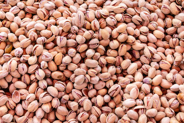 Bunch of unpeeled almonds. Background of raw unpeeled almonds. Close-up.