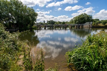 Obraz premium Reflection on the water, clouds above the Thames River