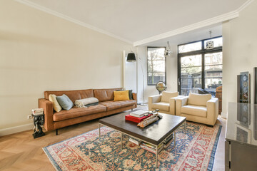 Studio apartment with white walls and open plan kitchen and dining zone with sofa in living room