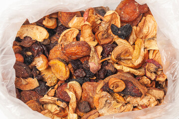 Dried fruits, apples, pears, apricots, plums,grapes,raisins,in package isolated on white background