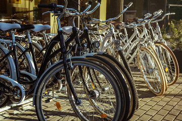 Bicycles in row for rent, near hotel. Vacation and lifestyle concept.