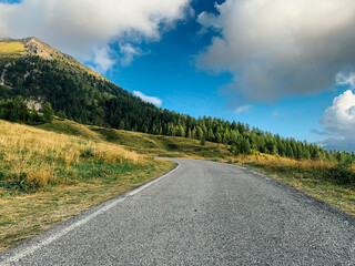 Fototapeta na wymiar Beautiful landscape with open road of mountainous area in the Italian Alps.