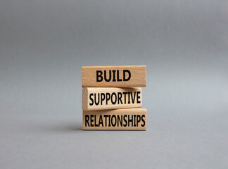 Build Supportive Ralationships symbol. Wooden blocks with words Build Supportive Ralationships. Beautiful grey background. Business and Build Supportive Ralationships. Copy space.