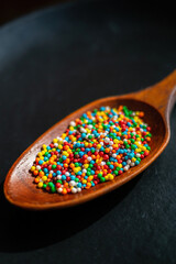 colorful sprinkles on the wooden spoon