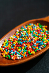 colorful sprinkles on the wooden spoon