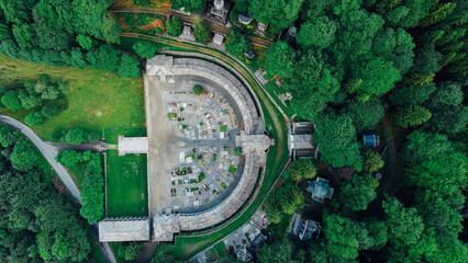 Aerial high angle view of The Monumental Cemetery of Oropa, graveyard built for noble families of the Biellese territory in Northern Italy. Semicircular architecture plan.