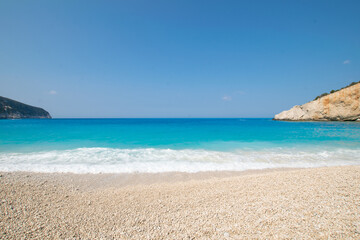 Turquoise sea and waves at Lefkada island during summer in Greece
