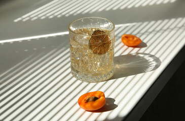 Drinks and cocktails. Minimalism. Whiskey with ice in a clear glass with lime chips and fresh...