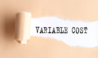 The text VARIABLE COST appears on torn paper on white background.