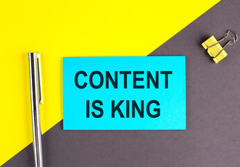 CONTENT IS KING text written on sticky with pen on grey, yellow background, business concept