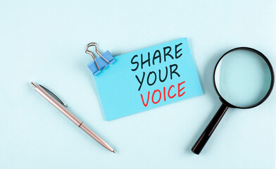 SHARE YOUR VOICE text written on a sticky with magnifier and pen, business concept