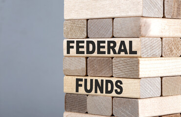 The text on the wooden blocks FEDERAL FUNDS
