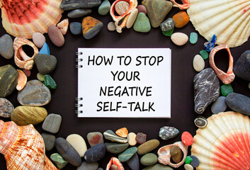 Stop negative self-talk symbol. Concept words How to stop your negative self-talk on beautiful black background. Sea stones and seashells. Psychological stop negative self-talk concept. Copy space.