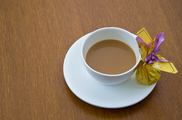 Cup of coffee with chocolate candy