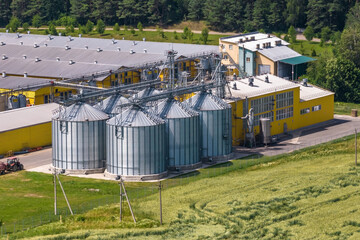 Fototapeta na wymiar silos and agro-industrial livestock complex on agro-processing and manufacturing plant with modern granary elevator. chicken farm. rows of chicken coop