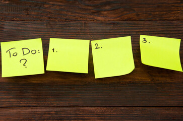 Yellow stickers on a wooden desk