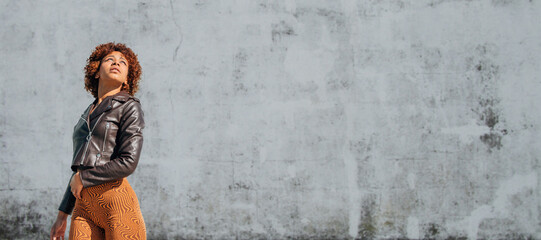 urban latin american girl with wall in background