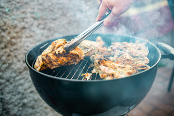 man chef cooking chicken meat on grill outdoor