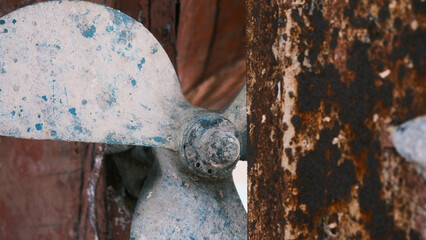 Big rusty propeller screw with rusty centerboard