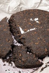 Chinese tea ripe Puer in the form of a round pancake on the table
