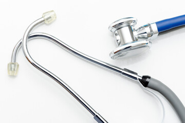Blue stethoscope on a white background. Close up view