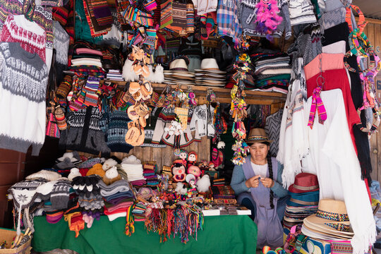 Latin woman weaving in a typical handcraft souvenir shop