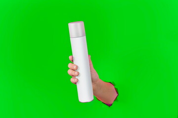 Clean Bottle Spray Flacon in the Hand. Cosmetic or Perfume Advertisement. Ready to use Item for Branding.  Photo for design. Chomakey Green Background