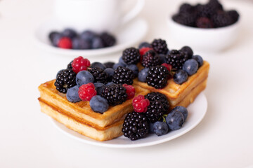 
Morning breakfast with cup of tea, waffles and berries