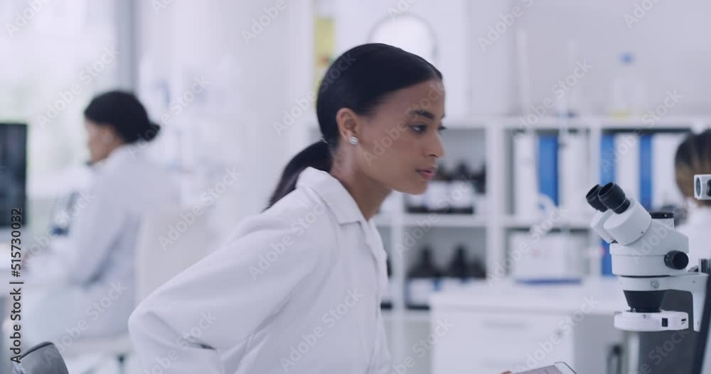 Aufkleber Young scientist using a digital tablet and computer in a lab. Dedicated woman doing forensic research while analyzing data and findings. Medical technician and clinical researcher working online