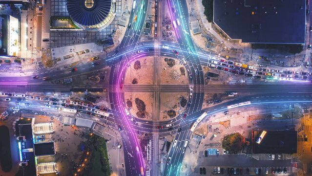 Top down hyperlapse shot of traffic on large road intersection. Visual effect highlighting traces of vehicles. Rondo Romana Dmowskiego, Warsaw, Poland